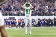 Oregon quarterback Bo Nix sits (#10) puts his hands on his helmet in disbelief as the No. 5 Ducks face the No. 3 Washington Huskies in the Pac-12 championship game at Allegiant Stadium in Las Vegas on Friday, Dec. 1, 2023. 