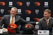 Oregon State athletic director Scott Barnes (left) jokes with new Beavers football coach Trent Bray during Bray’s introductory news conference on Wednesday, Nov. 29, 2023, in Corvallis. The Beavers promoted Bray from defensive coordinator to head coach.