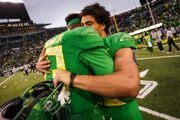 Oregon’s Anthony Brown Jr. (left) and Travis Dye celebrate after the No. 11 Ducks beat the Oregon State Beavers in their annual college football rivalry game on Saturday, Nov. 27, 2021, at Autzen Stadium in Eugene. Oregon won 38-29. Photo by Serena Morones for The Oregonian/OregonLive