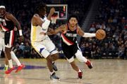 Portland Trail Blazers guard Anfernee Simons (1) drives against Golden State Warriors forward Kevon Looney during the first half of an NBA basketball game in San Francisco, Wednesday, Dec. 6, 2023. (AP Photo/Jed Jacobsohn) AP