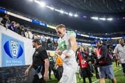 Oregon quarterback Bo Nix sits leaves the field after the No. 5 Ducks fall 34-31 to the No. 3 Washington Huskies in the Pac-12 championship game at Allegiant Stadium in Las Vegas on Friday, Dec. 1, 2023. 