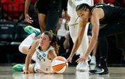 New York Liberty guard Sabrina Ionescu (20) and Las Vegas Aces center Kiah Stokes (41) fight for the ball during the second half of a WNBA basketball game Tuesday, Aug. 15, 2023, in Las Vegas. (Steve Marcus/Las Vegas Sun via AP)
