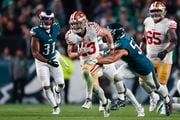 San Francisco 49ers running back Christian McCaffrey (23) runs as Philadelphia Eagles linebacker Christian Elliss (53) attempts a tackle during an NFL football game, Sunday, Dec, 3, 2023, in Philadelphia. the 49ers defeated the Eagles 42-19. (AP Photo/Rich Schultz)
