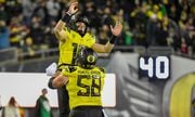 Oregon quarterback Bo Nix (10) celebrates with offensive lineman Jackson Powers-Johnson (58) after a touchdown against Southern California during the second half of an NCAA college football game Saturday, Nov. 11, 2023, in Eugene, Ore.