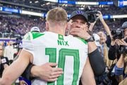 Oregon quarterback Bo Nix sits chats with Washington head coach Kalen DeBoer after the No. 5 Ducks fall 34-31 to the No. 3 Washington Huskies in the Pac-12 championship game at Allegiant Stadium in Las Vegas on Friday, Dec. 1, 2023. 