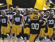 The Iowa Hawkeyes mascot runs onto the field, leading the team before the start of an NCAA college football game against Colorado State, Saturday, Sept. 25, 2021, in Iowa City, Iowa. (AP Photo/Ron Johnson)