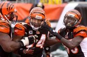 ** FILE ** In this Nov. 16, 2008 file photo, Cincinnati Bengals' T.J. Houshmandzadeh (84) is congratulated by Bobby Williams, left, and Chad Ocho Cinco, right, after Houshmandadeh scored a touchdown, during a NFL football game in Cincinnati. They arrived together from Oregon State in 2001, a pair of receivers who thought they could put some life into the Cincinnati Bengals' offense. For most of their eight years together, they did. Ocho Cinco and Houshmandzadeh made one playoff appearance together, reached the Pro Bowl together and became one of the league's best tandems. (AP Photo/Tony Tribble, File)