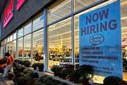 A hiring sign is displayed at a grocery store, Oct. 5, 2023, in Deerfield, Ill. Most business economists think the U.S. economy could avoid a recession in 2024, even if the job market ends up weakening under the weight of high interest rates, according to a survey released Monday, Dec. 4.