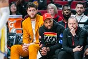 Portland Trail Blazers center Jusuf Nurki (left), guard Damian Lillard (middle) and assistant coach Steve Hetzel watch from the bench during an NBA game against the Golden State Warriors at Moda Center in Portland, Oregon on Sunday, April 9, 2023.