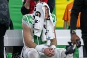 Oregon quarterback Bo Nix sits on the bench with a towel over his head after the No. 5 Ducks fall 34-31 to the No. 3 Washington Huskies in the Pac-12 championship game at Allegiant Stadium in Las Vegas on Friday, Dec. 1, 2023. 