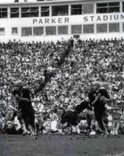 1962 -- BEAVERS 20, DUCKS 17 -- Oregon State quarterback Terry Baker, who would win the Heisman Trophy a few weeks later, rolls out agains the Ducks in 1962. Baker completed 8 of 17 passes for 90 yards and 2 touchdowns and ran for 27 yards.