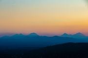 The sun sets over Central Oregon as seen from the top of Pilot Butte in Bend, Oregon on Thursday, July 13, 2023. 