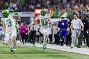 Oregon quarterback Bo Nix (#10) breaks a big run down the sideline as the No. 5 Ducks face the No. 3 Washington Huskies in the Pac-12 championship game at Allegiant Stadium in Las Vegas on Friday, Dec. 1, 2023. 