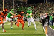 Oregon quarterback Bo Nix (10) runs the ball in for a touchdown during the first half as the No. 6 Ducks take on the No. 16 Oregon State Beavers in a Pac-12 football game on Friday, Nov. 24, 2023, at Autzen Stadium in Eugene. Oregon won 31-7 to clinch a spot in the Pac-12 championship game.
