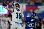 Carolina Panthers quarterback Jake Luton (16) passes under pressure from New York Giants cornerback Zyon Gilbert (38) during an NFL pre-season football game on Friday, Aug. 18, 2023, in East Rutherford, N.J. (AP Photo/Rusty Jones)