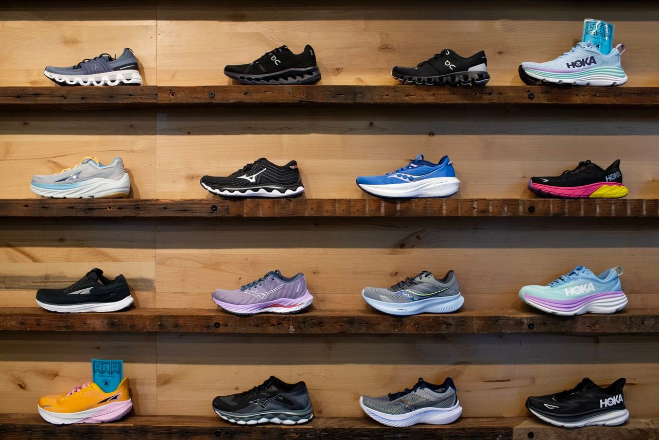 Running shoes for sale displayed on a wall